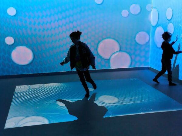 school children playing in immersive room